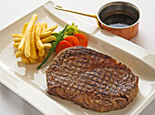 Kobe beef steak with chips and salad garnish