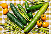 Assorted cucumbers, green asparagus and yellow egg tomatoes