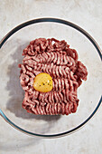 Raw ground meat with egg yolk, salt and pepper