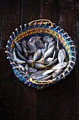 Fresh yellowtail mackerel in a basket