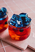 Colorful jello with fruit in a glass