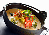 Thai chicken soup with chili and nuts