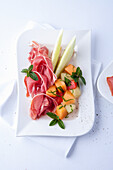Various types of melon with ham
