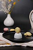 Still life with macarons, ceramic dish and vase