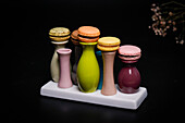 Macarons on colourful ceramic vases