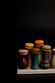 Macarons on colourful ceramic vases