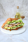 Croissant with ham, Maasdam cheese, lettuce, cucumber and Dijon mustard