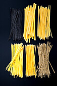 Various types of pasta on a black background