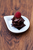 Chocolate squares with chocolate mousse and raspberry