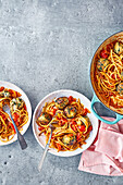 Meatballs with white beans and chard on spaghetti