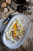 Fried eggs with black truffles