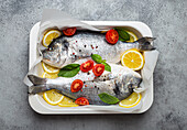 Raw gilthead with lemon, basil, and cherry tomatoes