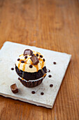 Chocolate cupcakes with caramel topping and toffee pralines