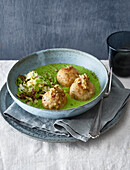 Crispy pretzel cheese dumplings with green velouté and roasted savoy cabbage