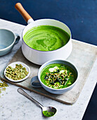 Detox green chicken soup with crunchy seed topper