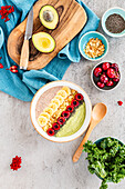 Two-colored smoothie bowl with avocado, kale, and cherries