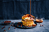Pancakes with fried bananas, whipped cream, and caramel sauce