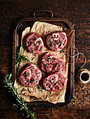 Slices of beef leg with rosemary