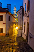 Narrow cobblestone streets at dusk with Castle Tower in historic Cesky Krumlov, Czech Republic. (Editorial Use Only)