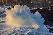 Waves crashing into the rocky shoreline near Dingle, Ireland
