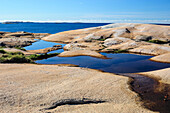 Sweden, Bohuslan, Ramsviklandet Nature Preserve. Polished rock slabs along the coast.