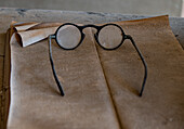 Old glasses collect dust in an old general store, California, USA.