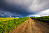 Storm clouds over West Spring Creek Road in the Flathead Valley, Montana, USA