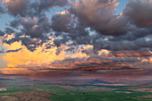 Stormy clouds at sunset over rolling hills from Steptoe Butte near Colfax, Washington State, USA
