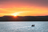Fishing from boat on Soda Lake at sunset, Wyoming