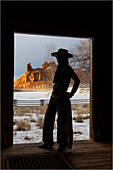 USA, Shell, Wyoming. Hideout Ranch mit Cowgirl vor der Tür einer Blockhütte (PR,MR)
