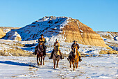 USA, Wyoming. Hideout Horse Ranch, wranglers and horses in snow. (MR,PR)