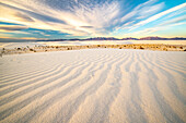 USA, New Mexico, White Sands National Monument. White sand dunes and clouds.