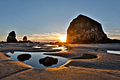 USA, Oregon. Cannon Beach mit Haystack bei Sonnenuntergang und Ebbe.
