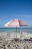 Sonnenschirm und Liegestühle am Lido Beach