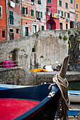 View of colourful buildings and boats in a river in Riomaggiore in Cinque Terra; Riomaggiore, Liguria, Italy