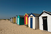 Traditional beach huts in the sand dunes at Southwold, Suffolk, UK