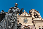 A Statue Of St. Francis Of Assisi Prominently Adorns The Front Entrance Of The St. Francis Cathedral In Santa Fe, New Mexico, Usa