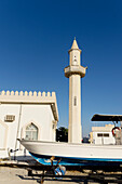 United Arab Emirates, Boat in front of mosque; Ras Al Khaimah