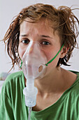 United Kingdom, England, Teenager with nebuliser; Esher