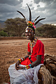 Kenya, Portrait of young Samburu Moran (warrior) in traditional dress; South Horr