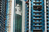 VAE, Großes Porträt von Scheich Mohammed Bin Rashid Al Maktoum auf einem Gebäude neben anderen im Bau befindlichen Gebäuden; Dubai