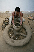 A Man Working On A Pottery Wheel, Potters Village; Madhya Pradesh, India