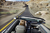 Usa, California, Young Woman Driving Convertible Car; Death Valley National Park