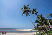 People relaxing on Ashwem Beach in North Goa; Ashwem, Goa, India