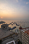 Sun rise over the harbor with the Gateway of India and the Taj Mahal Palace Hotel at dawn; Mumbai, Bombay, India