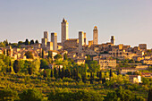 Medieval town of San Gimignano with it many towers (Torri di San Gimignano), Torre Grossa being the tallest, surrounded by the Tuscan countryside; San Gimignano, Tuscany, Italy