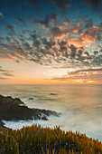 Mist over the ocean at sunset at Praia do Carvalhal, Portugal; Alentejo, Portugal