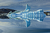 Sculpted iceberg and reflection in Semerlik Fjord.