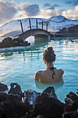 A woman swimming in Iceland's blue lagoon.