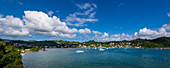 View of the Town of Samana overlooking Samana Bay with boats moored in the harbor on a sunny day; Samana Peninsula, Dominican Republic, Caribbean